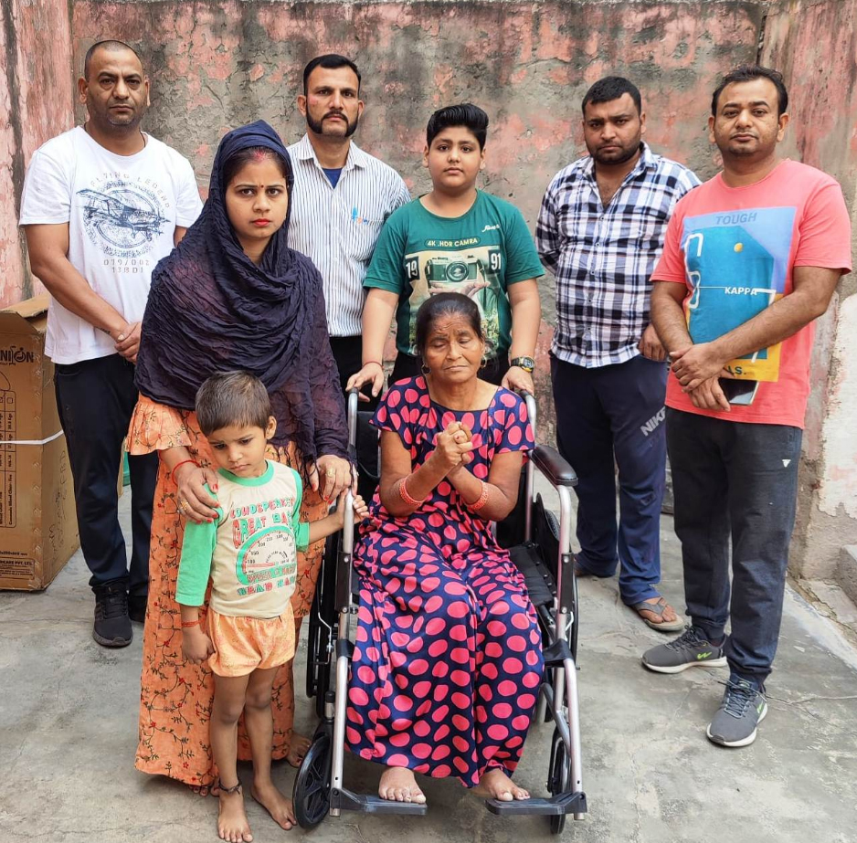 Public welfare service organization presented a tricycle to an elderly woman