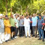 Shyam Sundar Kapoor distributed laddus on Krishan Pal Gurjar's victory hat-trick and becoming a minister.