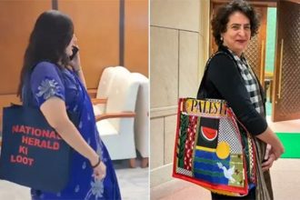 Bansuri Swaraj seen carrying a bag with 'National Herald looted' written on it